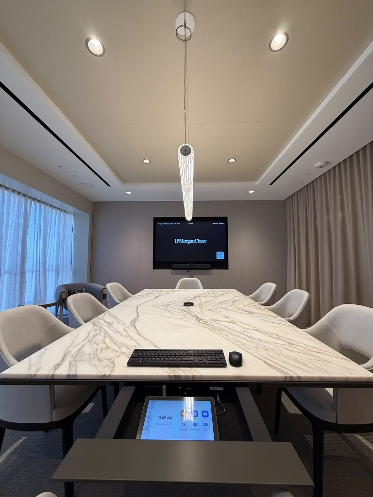 Boardroom with a marble table, wall display and a tabletop control touch panel