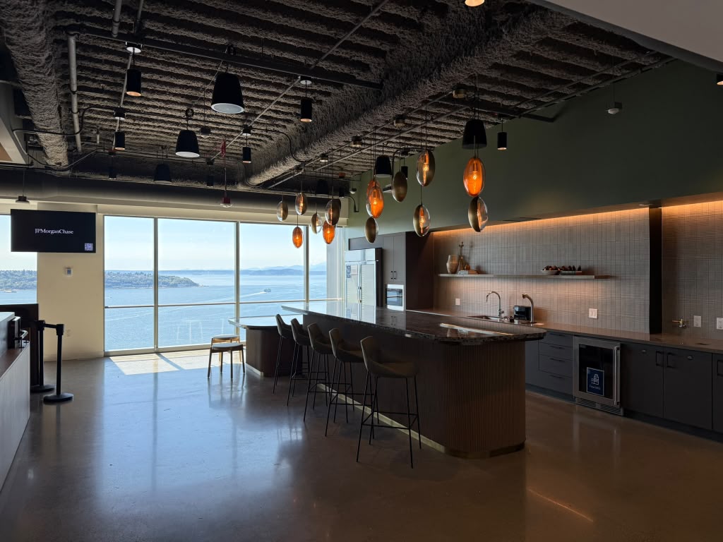 Waterfront office lounge and bar with pendant lighting and wall mounted signage